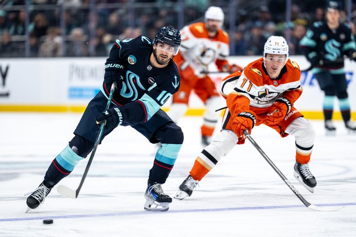 Jan 28, 2025; Seattle, Washington, USA;  Seattle Kraken forward Matty Beniers (10) passes the puck against Anaheim Ducks forward Trevor Zegras (11) during the second period at Climate Pledge Arena. Mandatory Credit: Stephen Brashear-Imagn Images