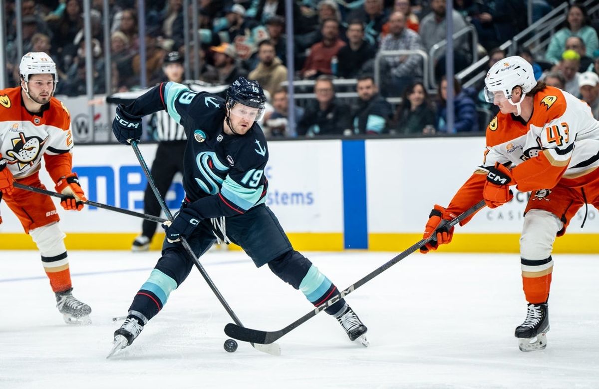 Jan 28, 2025; Seattle, Washington, USA;  Seattle Kraken forward Jared McCann (19) battles Anaheim Ducks defenseman Drew Helleson (43) for the puck during the second period at Climate Pledge Arena. Mandatory Credit: Stephen Brashear-Imagn Images