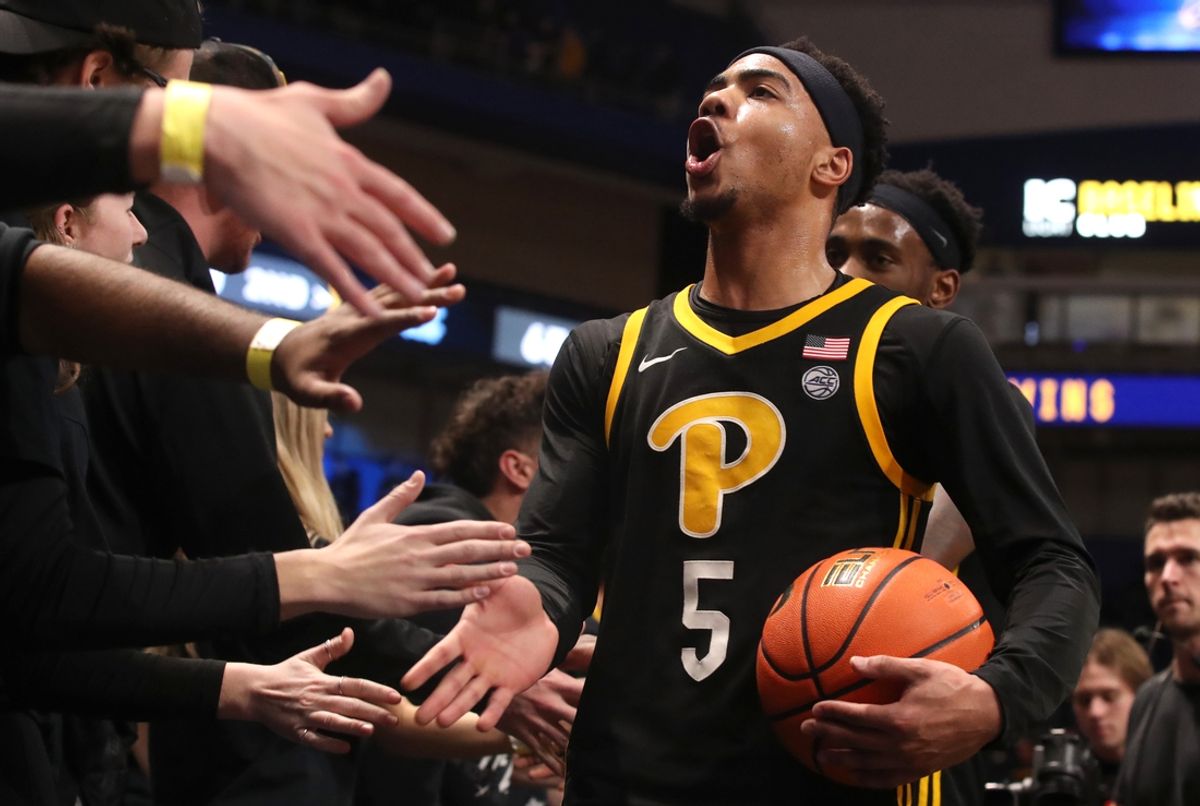 Jan 28, 2025; Pittsburgh, Pennsylvania, USA;  Pittsburgh Panthers guard Ishmael Leggett (5) celebrates with the student section after defeating the North Carolina Tar Heels at the Petersen Events Center. Mandatory Credit: Charles LeClaire-Imagn Images