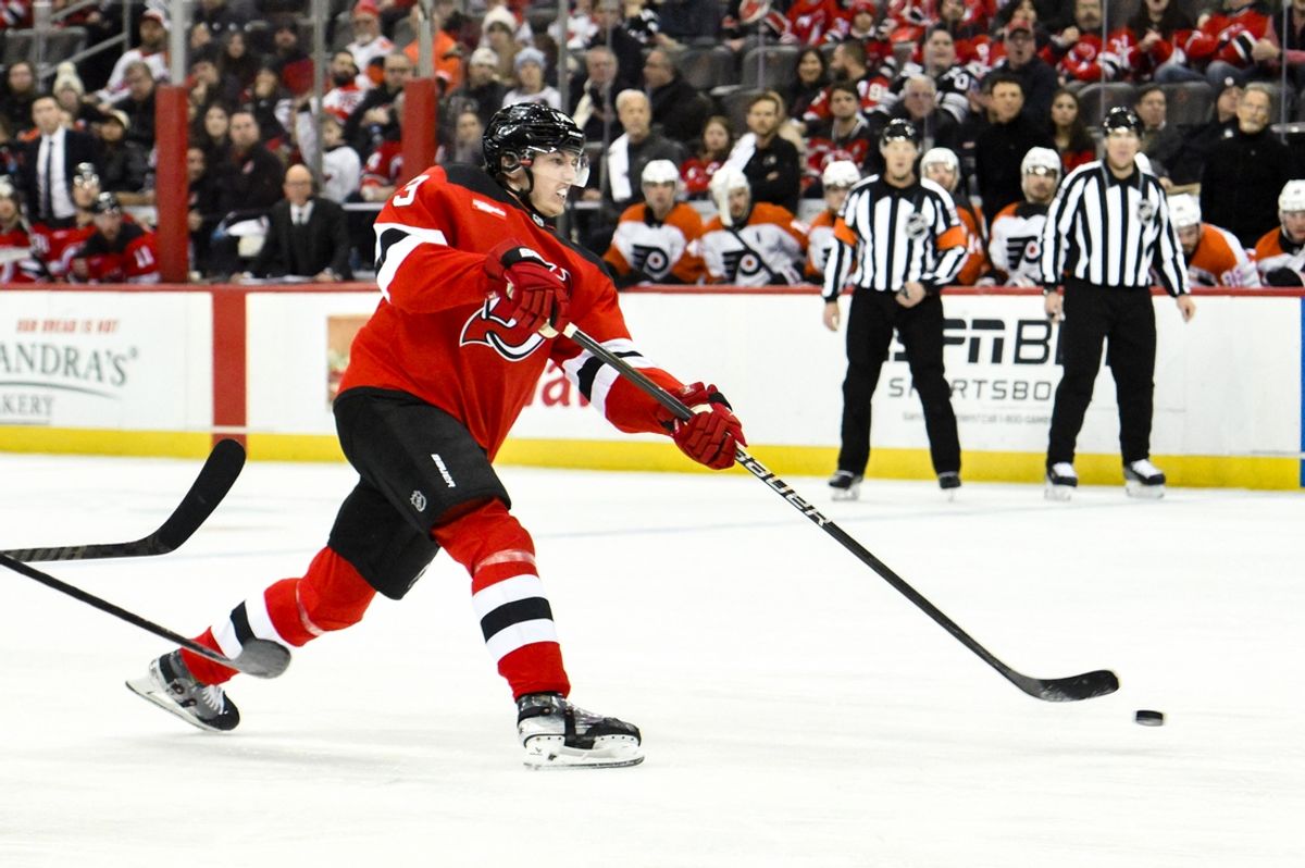 Jan 29, 2025; Newark, New Jersey, USA; New Jersey Devils defenseman Luke Hughes (43) takes a shot on goal against the Philadelphia Flyers during the first period at Prudential Center. Mandatory Credit: John Jones-Imagn Images