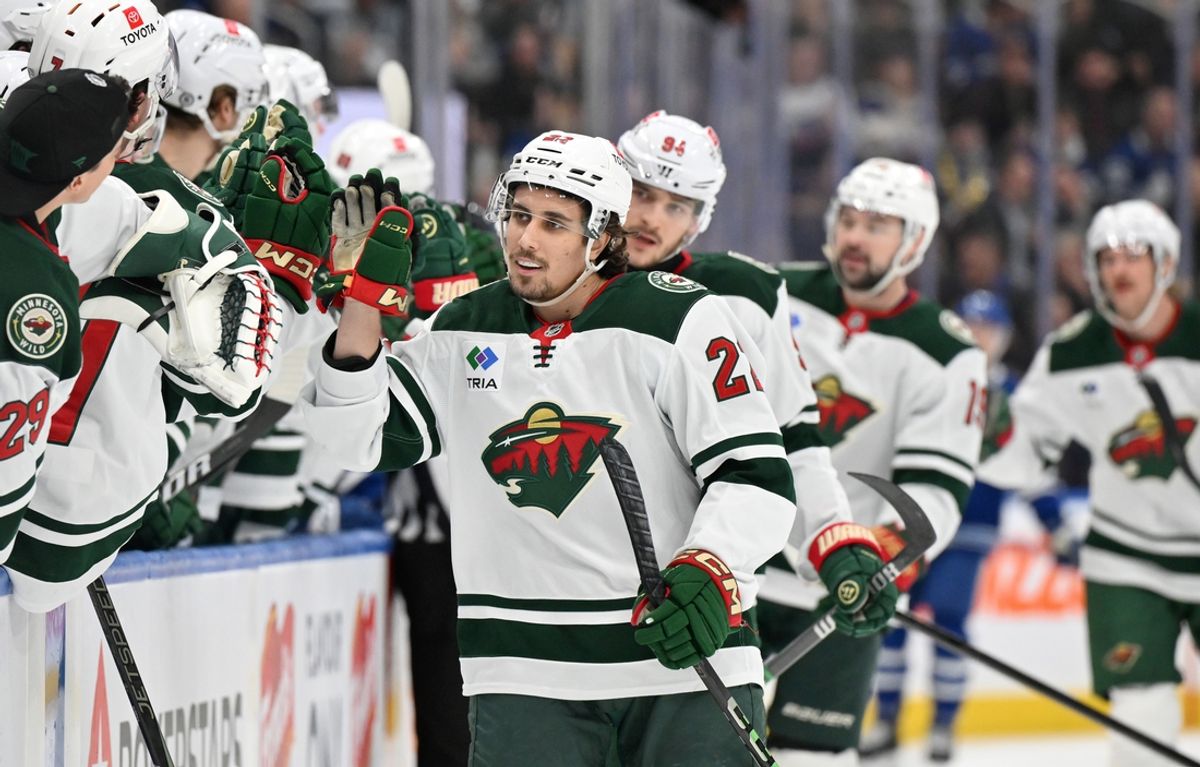 Jan 29, 2025; Toronto, Ontario, CAN;  Minnesota Wild forward Marat Khusnutdinov (22) celebrates with team mates at the bench after scoring a goal against the Toronto Maple Leafs in the first period at Scotiabank Arena. Mandatory Credit: Dan Hamilton-Imagn Images