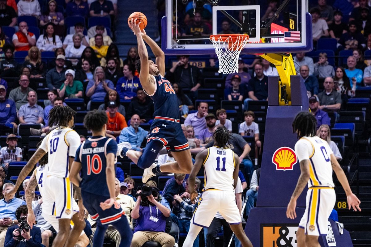 Jan 29, 2025; Baton Rouge, Louisiana, USA;  Auburn Tigers center Dylan Cardwell (44) dunks the ball against LSU Tigers forward Corey Chest (11) during the first half at Pete Maravich Assembly Center. Mandatory Credit: Stephen Lew-Imagn Images