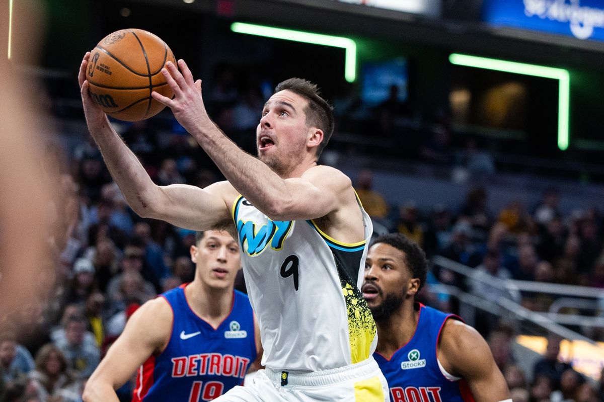 Jan 29, 2025; Indianapolis, Indiana, USA; Indiana Pacers guard T.J. McConnell (9) shoots the ball while Detroit Pistons guard Malik Beasley (5) defends in the first half at Gainbridge Fieldhouse. Mandatory Credit: Trevor Ruszkowski-Imagn Images