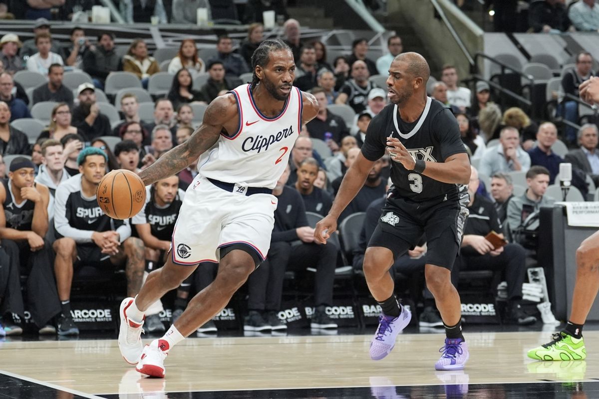 Jan 29, 2025; San Antonio, Texas, USA;  LA Clippers forward Kawhi Leonard (2) dribbles against San Antonio Spurs guard Chris Paul (3) in the first half at Frost Bank Center. Mandatory Credit: Daniel Dunn-Imagn Images