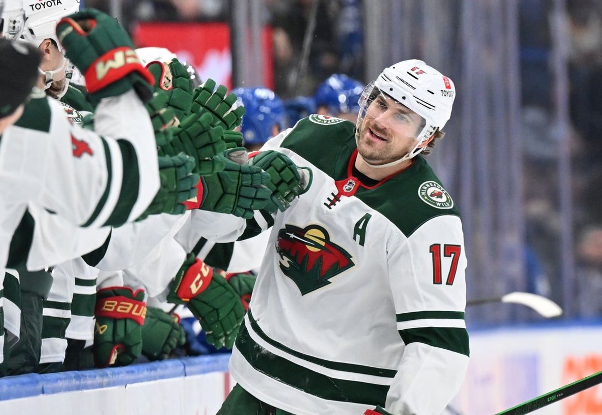 Jan 29, 2025; Toronto, Ontario, CAN; Minnesota Wild forward Marcus Foligno (17) celebrates with team mates at the bench after scoring a goal against the Toronto Maple Leafs in the third period at Scotiabank Arena. Mandatory Credit: Dan Hamilton-Imagn Images