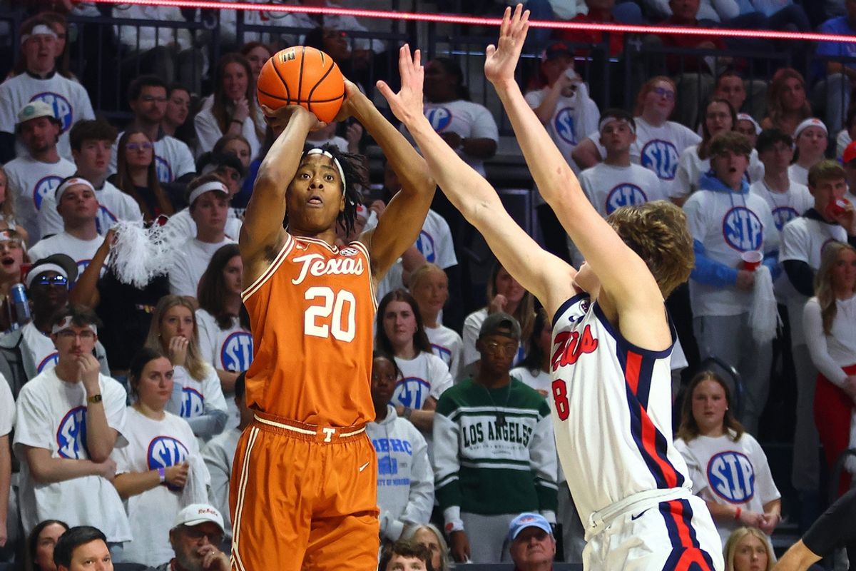 Jan 29, 2025; Oxford, Mississippi, USA; Texas Longhorns guard Tre Johnson (20) shoots fa three point basket as Mississippi Rebels guard Eduardo Klafke (8) defends during the first half at The Sandy and John Black Pavilion at Ole Miss. Mandatory Credit: Petre Thomas-Imagn Images