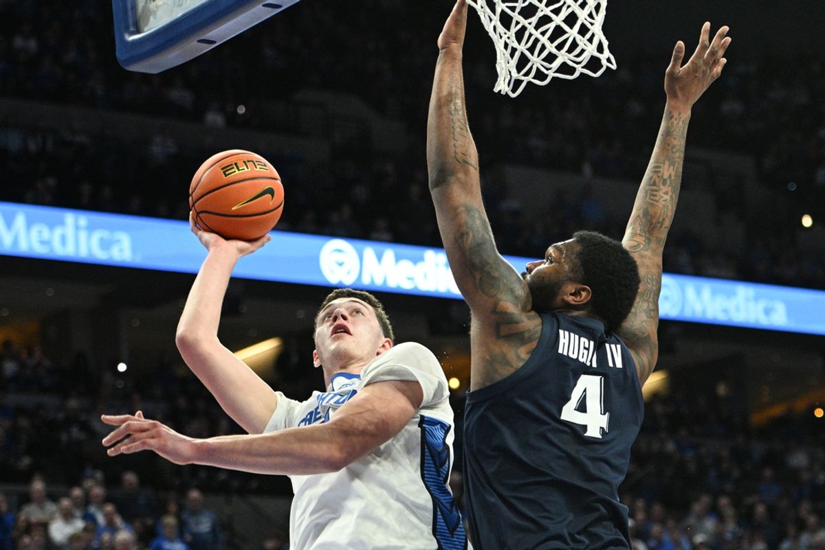 Jan 29, 2025; Omaha, Nebraska, USA;  Creighton Bluejays center Ryan Kalkbrenner (11) shoots over Xavier Musketeers forward John Hugley IV (4) during the second half at CHI Health Center Omaha. Mandatory Credit: Steven Branscombe-Imagn Images