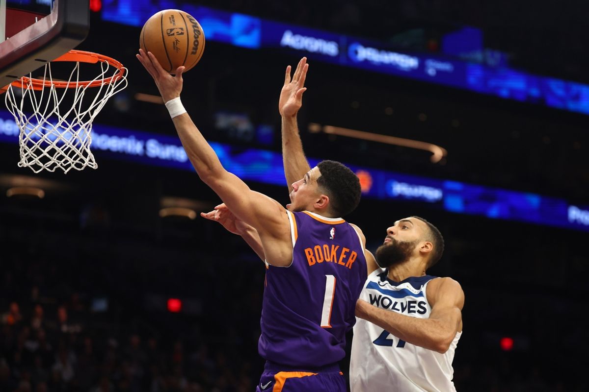 Jan 29, 2025; Phoenix, Arizona, USA; Phoenix Suns guard Devin Booker (1) shoots the ball over Minnesota Timberwolves center Rudy Gobert (27) in the second half at Footprint Center. Mandatory Credit: Mark J. Rebilas-Imagn Images