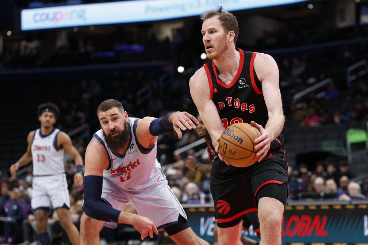 Jan 29, 2025; Washington, District of Columbia, USA; Toronto Raptors center Jakob Poeltl (19) holds the ball as Washington Wizards center Jonas Valanciunas (17) reaches in the second quarter at Capital One Arena. Mandatory Credit: Geoff Burke-Imagn Images