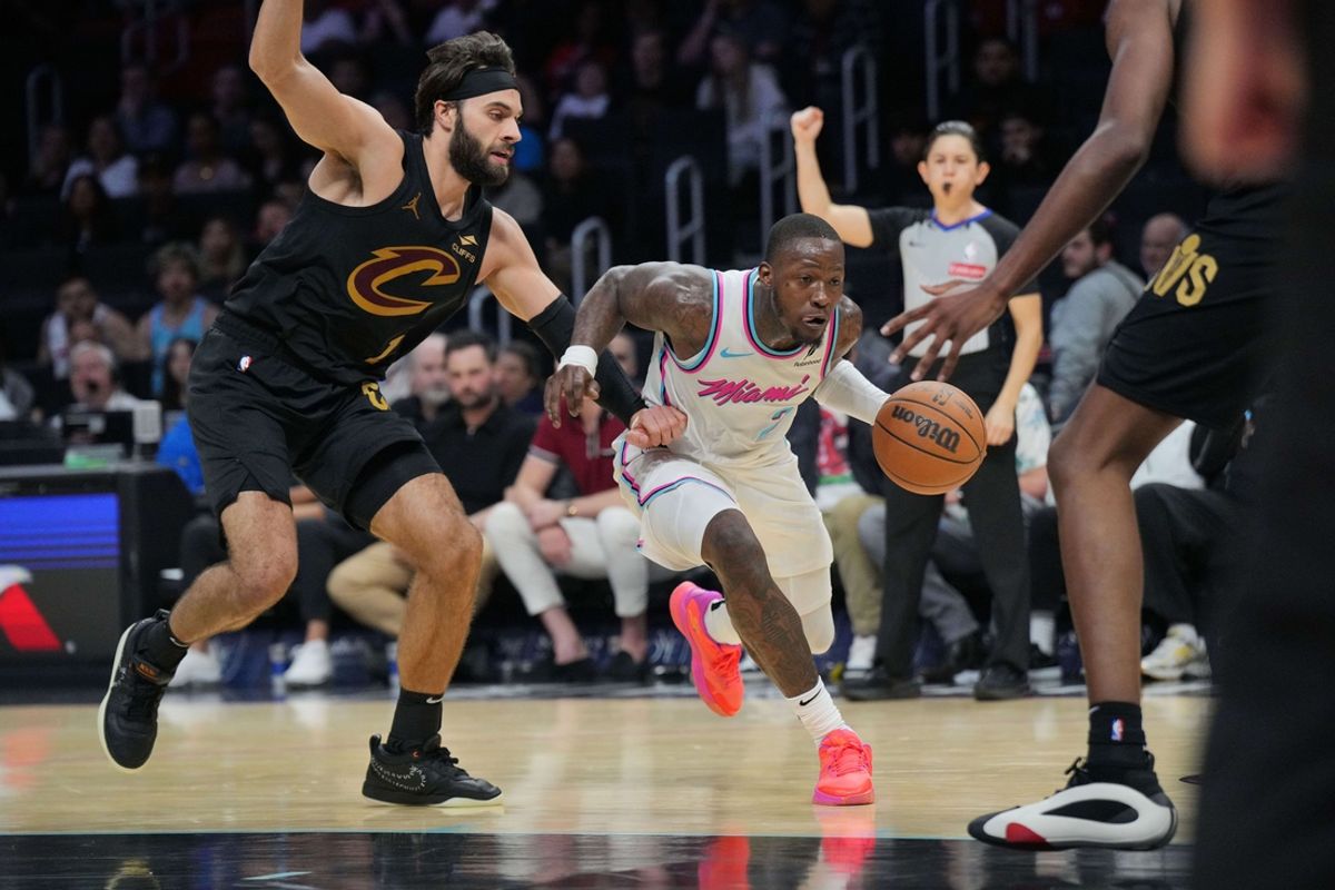 Jan 29, 2025; Miami, Florida, USA;  Miami Heat guard Terry Rozier (2) drives to the basket and gets fouled by Cleveland Cavaliers guard Max Strus (1) during the second half at Kaseya Center. Mandatory Credit: Jim Rassol-Imagn Images