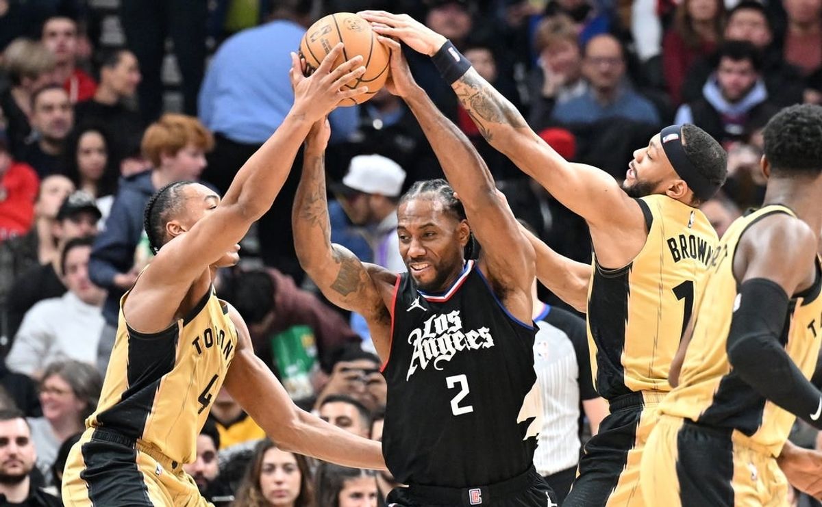 Jan 26, 2024; Toronto, Ontario, CAN;   Los Angeles Clippers forward Kawhi Leonard (2) battles for the ball against Toronto Raptors forward Scottie Barnes (4) and guard Bruce Brown (11) in the first half at Scotiabank Arena.