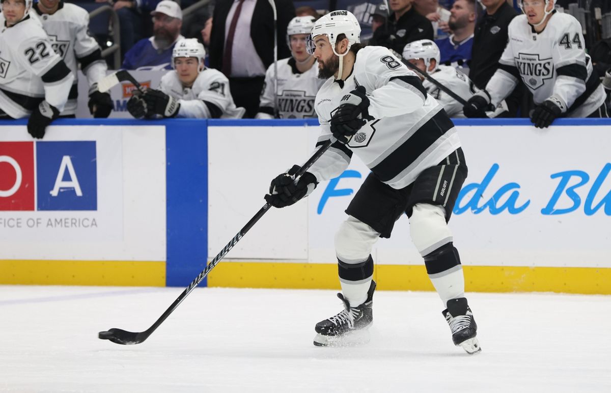 Jan 30, 2025; Tampa, Florida, USA;  Los Angeles Kings defenseman Drew Doughty (8) passes the puck against the Tampa Bay Lightning during the first period at Amalie Arena. Mandatory Credit: Kim Klement Neitzel-Imagn Images