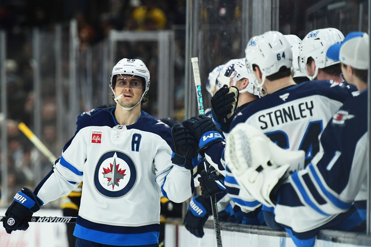 Jan 30, 2025; Boston, Massachusetts, USA; Winnipeg Jets center Mark Scheifele (55) celebrates with teammates after scoring a goal during the first period against the Boston Bruins at TD Garden. Mandatory Credit: Bob DeChiara-Imagn Images