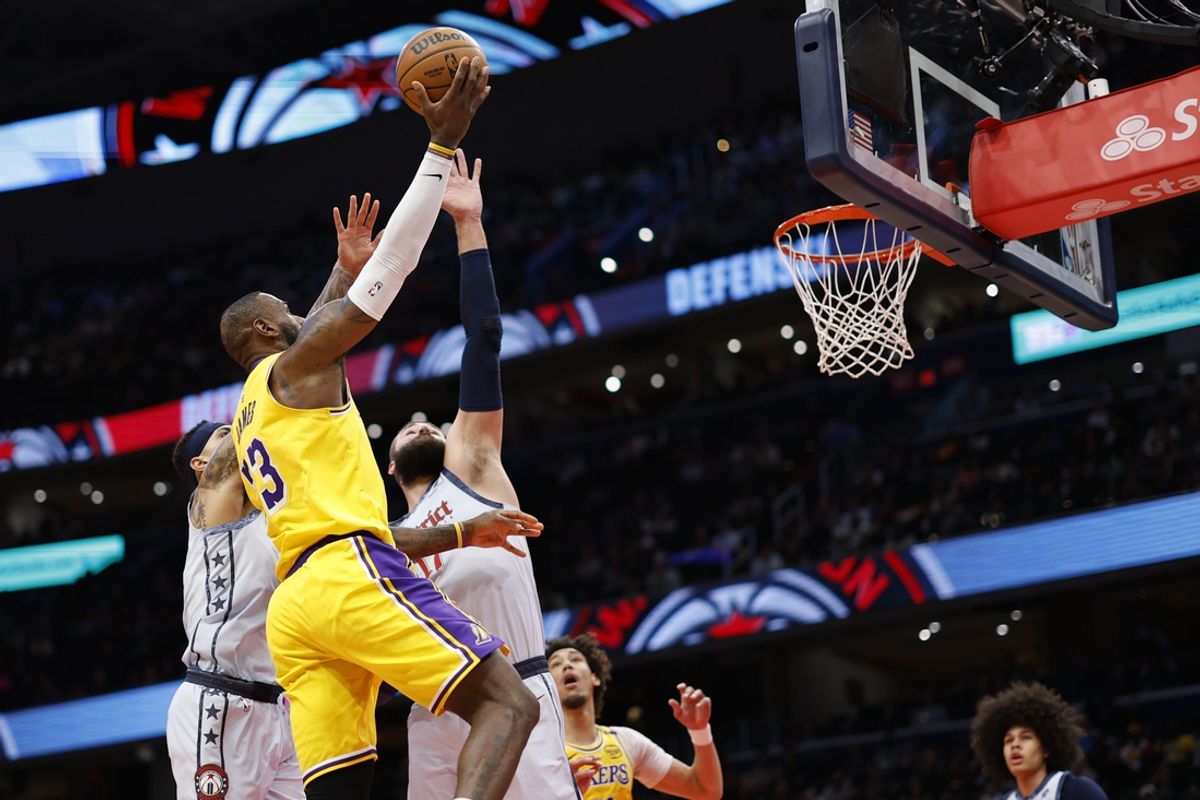 Jan 29, 2025; Washington, District of Columbia, USA; Los Angeles Lakers forward LeBron James (23) shoots the ball as Washington Wizards center Jonas Valanciunas (17) defends in the first quarter at Capital One Arena. Mandatory Credit: Geoff Burke-Imagn Images
