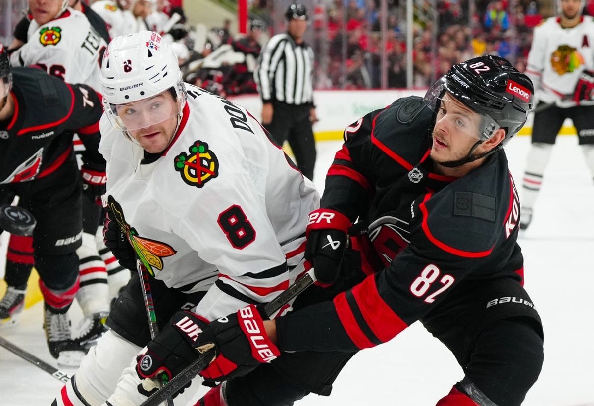 Jan 30, 2025; Raleigh, North Carolina, USA; Carolina Hurricanes center Jesperi Kotkaniemi (82) and Chicago Blackhawks center Ryan Donato (8) watch the play during the second period at Lenovo Center. Mandatory Credit: James Guillory-Imagn Images