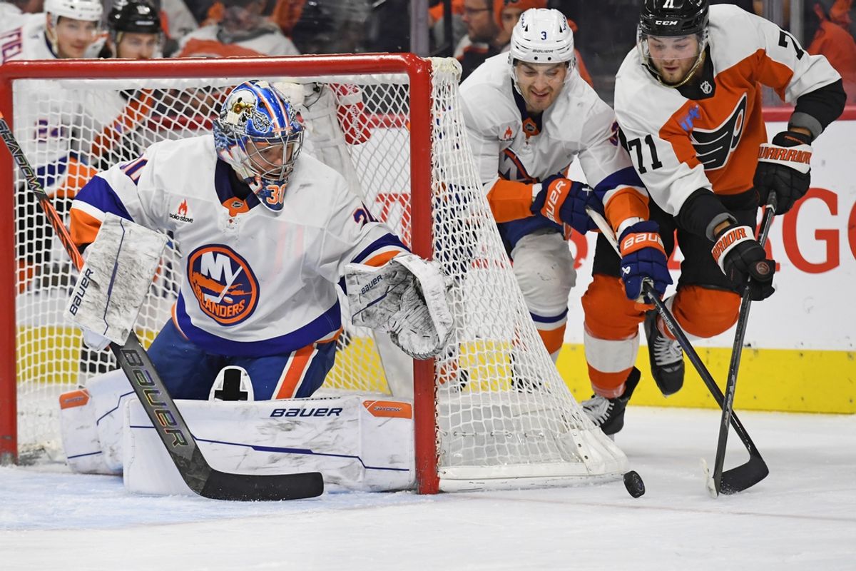 Jan 30, 2025; Philadelphia, Pennsylvania, USA; Philadelphia Flyers right wing Tyson Foerster (71) and New York Islanders defenseman Adam Pelech (3) battle for the puck with goaltender Ilya Sorokin (30 during the second period at Wells Fargo Center. Mandatory Credit: Eric Hartline-Imagn Images