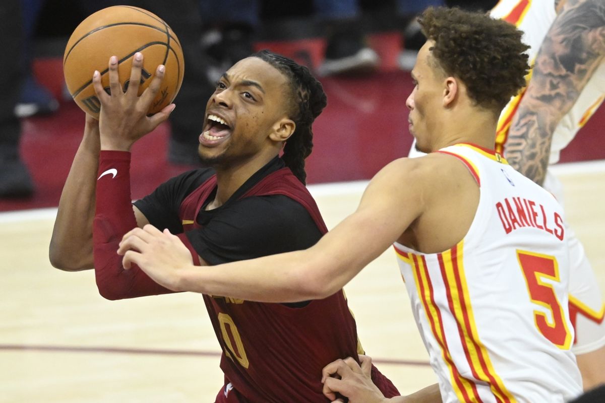 Jan 30, 2025; Cleveland, Ohio, USA; Cleveland Cavaliers guard Darius Garland (10) drives against Atlanta Hawks guard Dyson Daniels (5) in the fourth quarter at Rocket Mortgage FieldHouse. Mandatory Credit: David Richard-Imagn Images