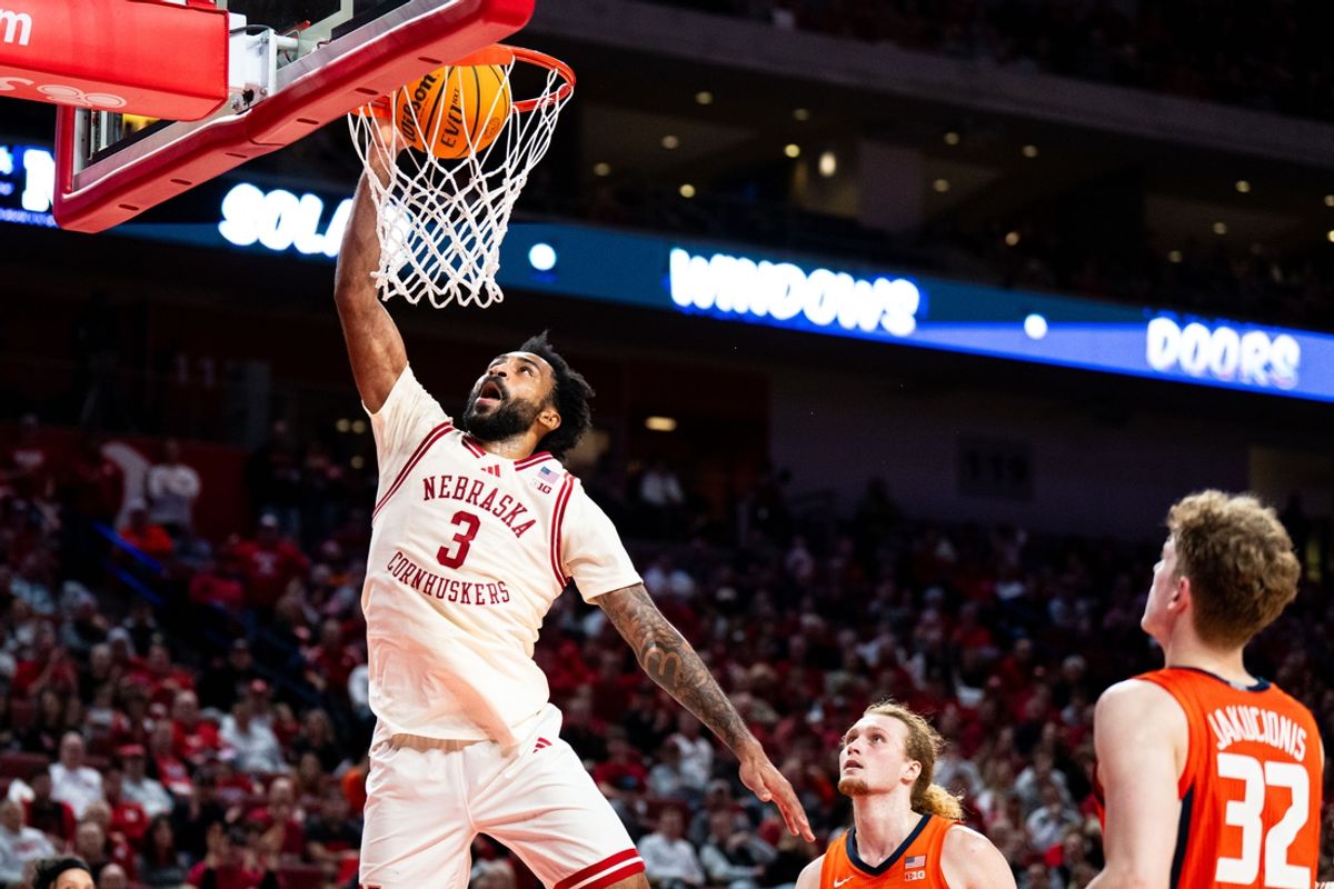 Jan 30, 2025; Lincoln, Nebraska, USA; Nebraska Cornhuskers guard Brice Williams (3) dunks the ball against Illinois Fighting Illini forward Jake Davis (15) and guard Kasparas Jakucionis (32) during the first half at Pinnacle Bank Arena. Mandatory Credit: Dylan Widger-Imagn Images