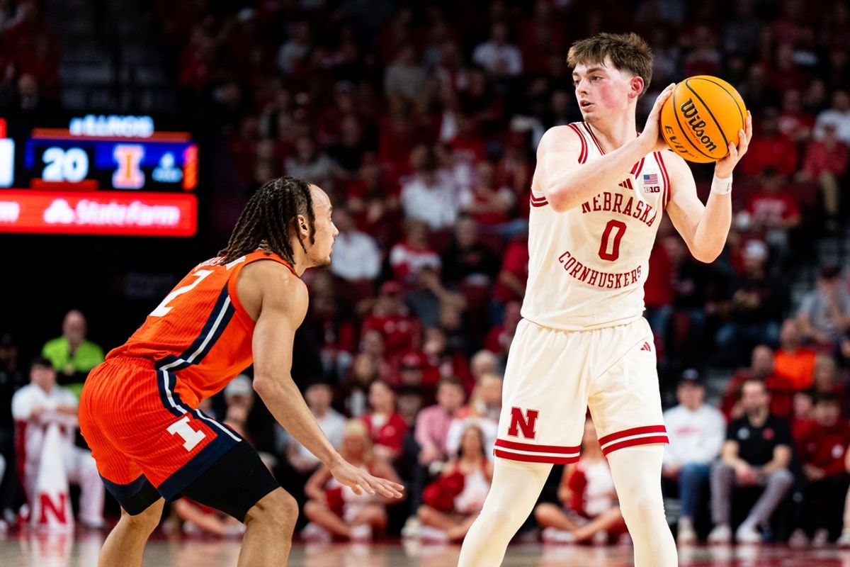 Jan 30, 2025; Lincoln, Nebraska, USA; Nebraska Cornhuskers guard Connor Essegian (0) looks to pass against Illinois Fighting Illini guard Dra Gibbs-Lawhorn (2) during the first half at Pinnacle Bank Arena. Mandatory Credit: Dylan Widger-Imagn Images