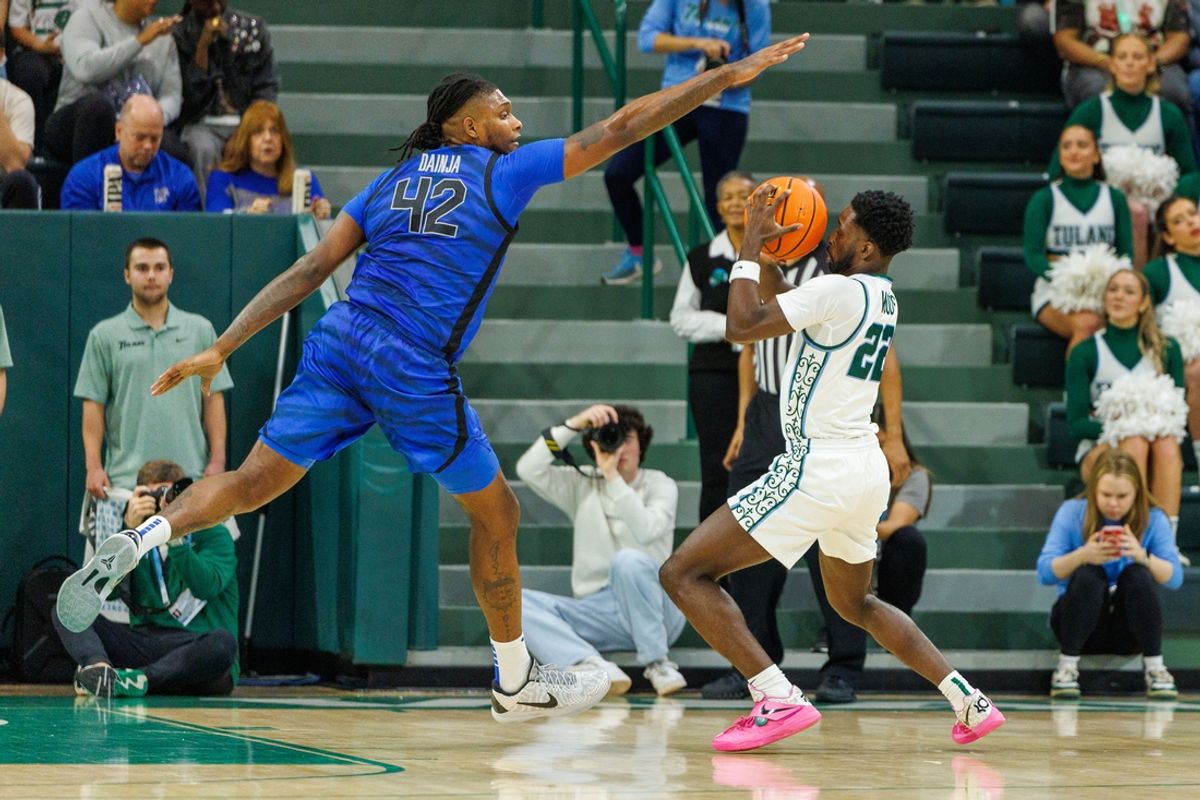 Jan 30, 2025; New Orleans, Louisiana, USA;  Memphis Tigers forward Dain Dainja (42) attempt to block a shot by Tulane Green Wave guard Asher Woods (22) during the first half at Avron B. Fogelman Arena in Devlin Fieldhouse. Mandatory Credit: Stephen Lew-Imagn Images