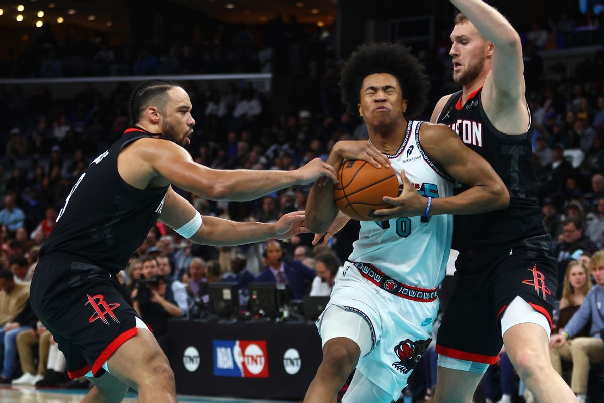 Jan 30, 2025; Memphis, Tennessee, USA; Memphis Grizzlies forward Jaylen Wells (0) drives to the basket between Houston Rockets forward Dillon Brooks (9) and center Jock Landale (2) during the first quarter at FedExForum. Mandatory Credit: Petre Thomas-Imagn Images