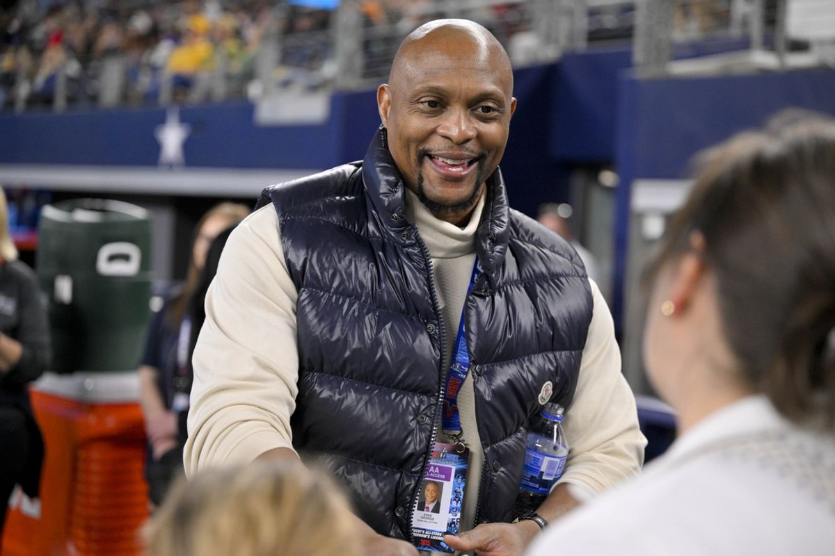 Jan 30, 2025; Arlington, TX, USA; Former NFL player Eddie George signs a football for the fans during the second half of the game between the East and the West at AT&T Stadium. Mandatory Credit: Jerome Miron-Imagn Images