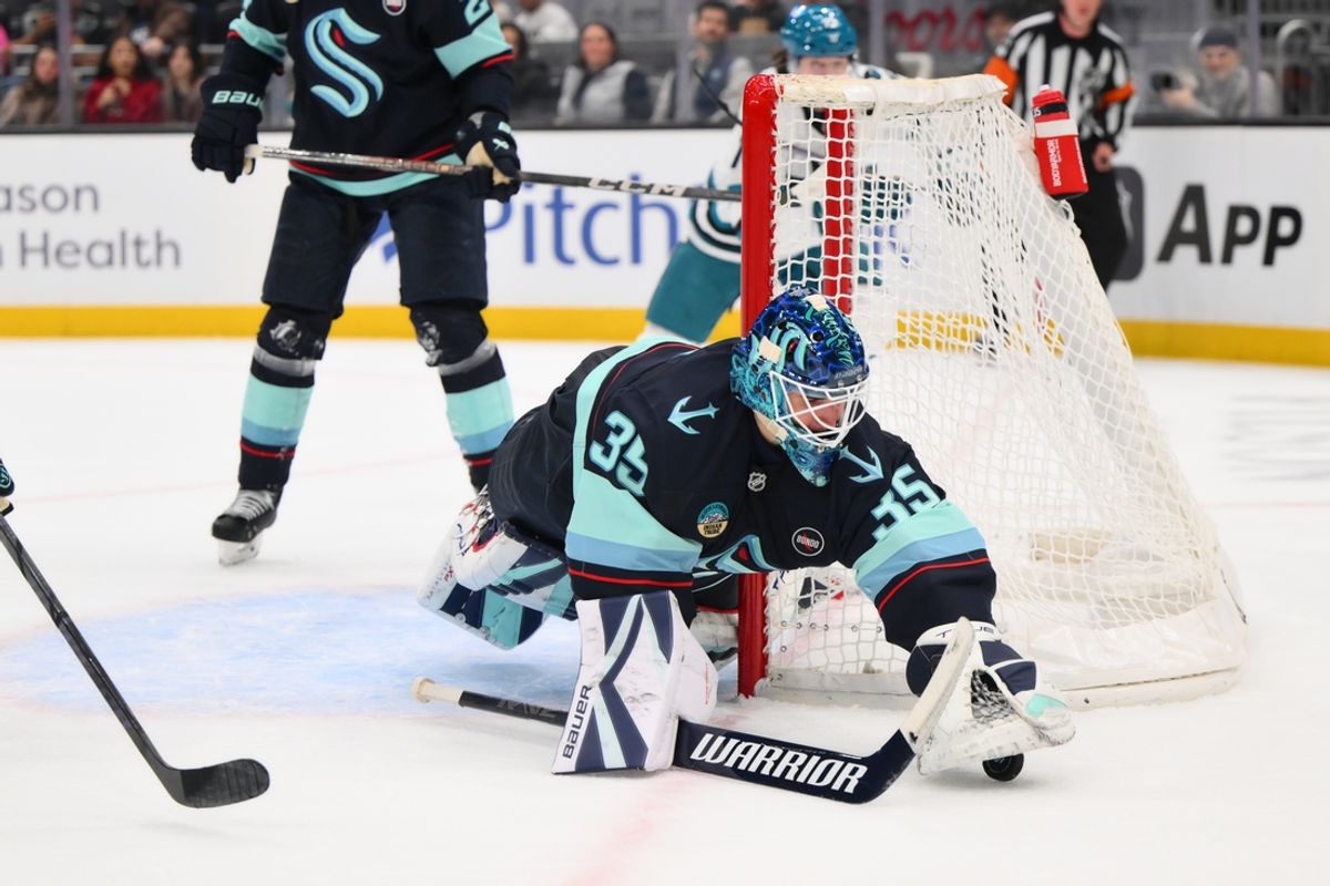 Jan 30, 2025; Seattle, Washington, USA; Seattle Kraken goaltender Joey Daccord (35) traps the puck during the second period against the San Jose Sharks at Climate Pledge Arena. Mandatory Credit: Steven Bisig-Imagn Images