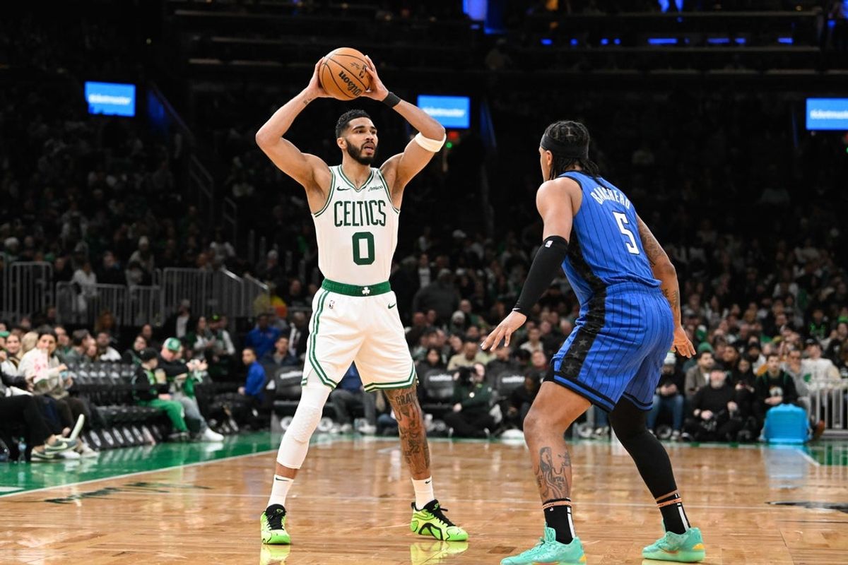 Jan 17, 2025; Boston, Massachusetts, USA; Boston Celtics forward Jayson Tatum (0) looks to pass the ball over Orlando Magic forward Paolo Banchero (5) during the second half at TD Garden. Mandatory Credit: Eric Canha-Imagn Images