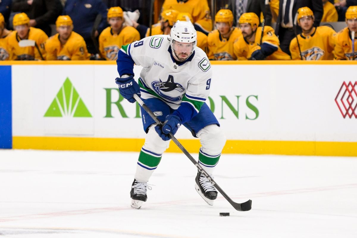 Jan 29, 2025; Nashville, Tennessee, USA;  Vancouver Canucks center J.T. Miller (9) skates with the puck against the Nashville Predators during the second period at Bridgestone Arena. Mandatory Credit: Steve Roberts-Imagn Images