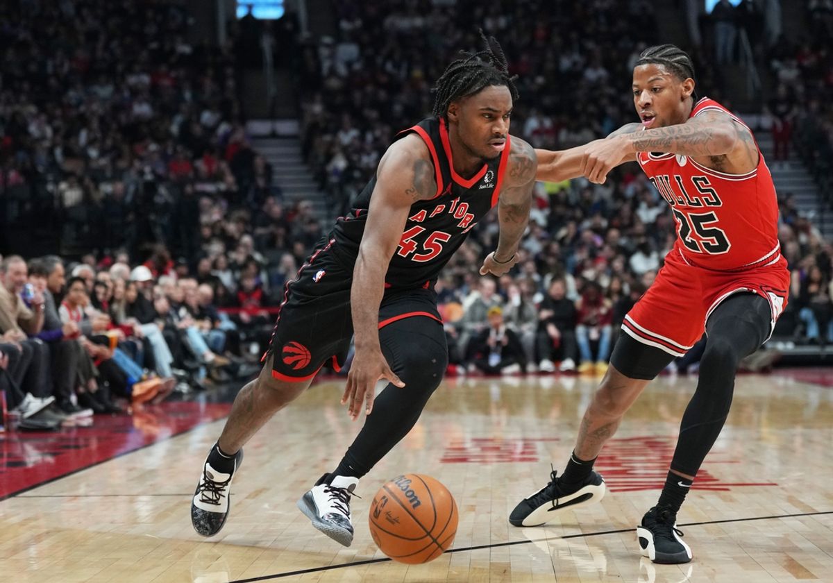 Jan 31, 2025; Toronto, Ontario, CAN; Toronto Raptors guard Davion Mitchell (45) controls the ball as Chicago Bulls forward Dalen Terry (25) tries to defend during the second quarter at Scotiabank Arena. Mandatory Credit: Nick Turchiaro-Imagn Images