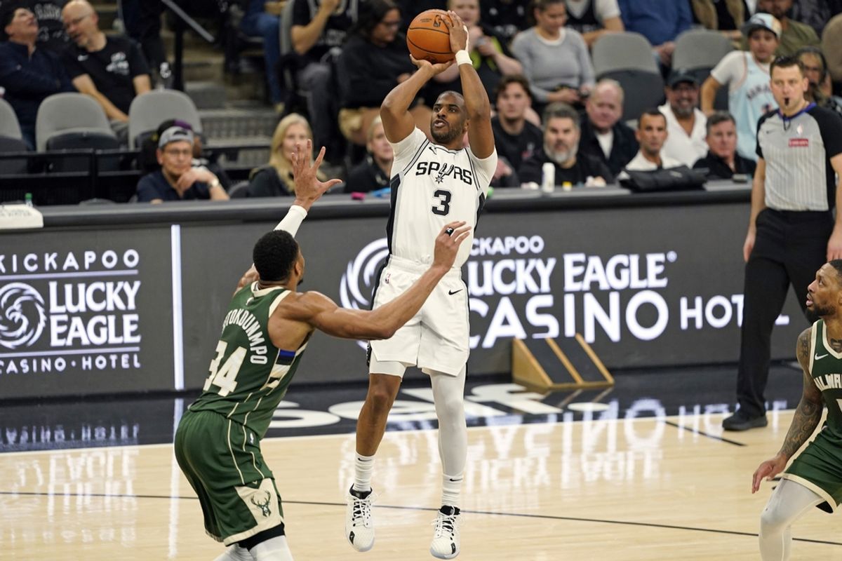 Jan 31, 2025; San Antonio, Texas, USA; San Antonio Spurs guard Chris Paul (3) shoots over Milwaukee Bucks forward Giannis Antetokounmpo (34) during the first half at Frost Bank Center. Mandatory Credit: Scott Wachter-Imagn Images