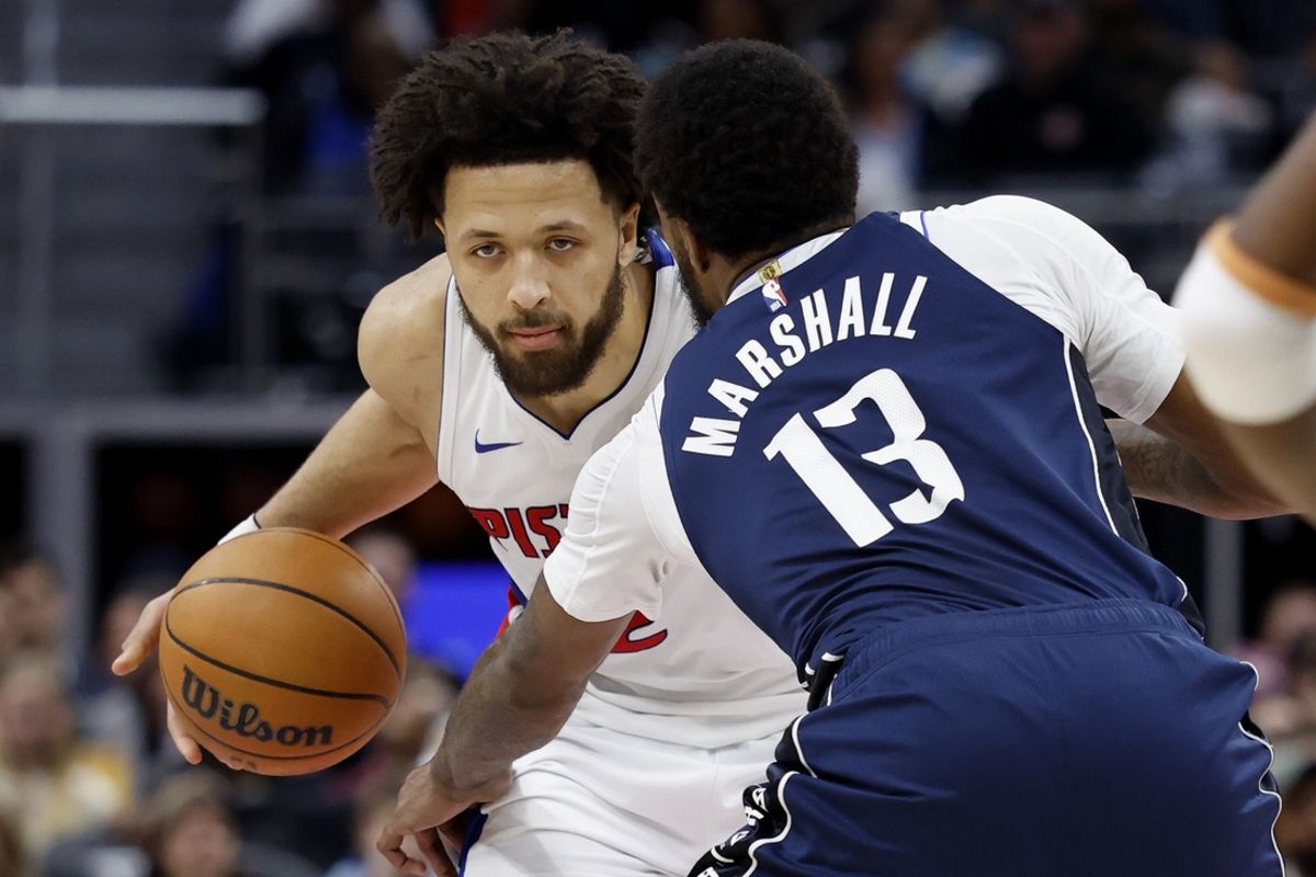 Jan 31, 2025; Detroit, Michigan, USA;  Detroit Pistons guard Cade Cunningham (2) dribbles defended by Dallas Mavericks forward Naji Marshall (13) in the second half at Little Caesars Arena. Mandatory Credit: Rick Osentoski-Imagn Images