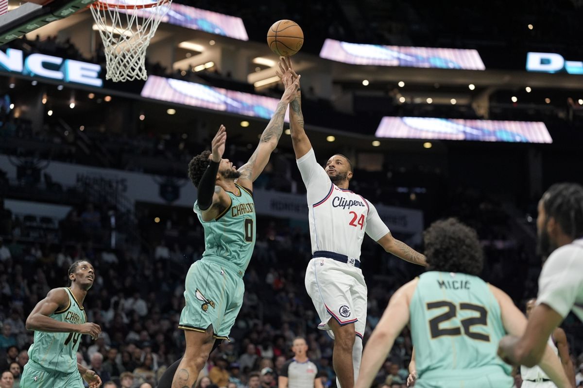 Jan 31, 2025; Charlotte, North Carolina, USA; LA Clippers guard Norman Powell (24) goes up for the jumper against Charlotte Hornets forward Miles Bridges (0) during the second half at Spectrum Center. Mandatory Credit: Jim Dedmon-Imagn Images