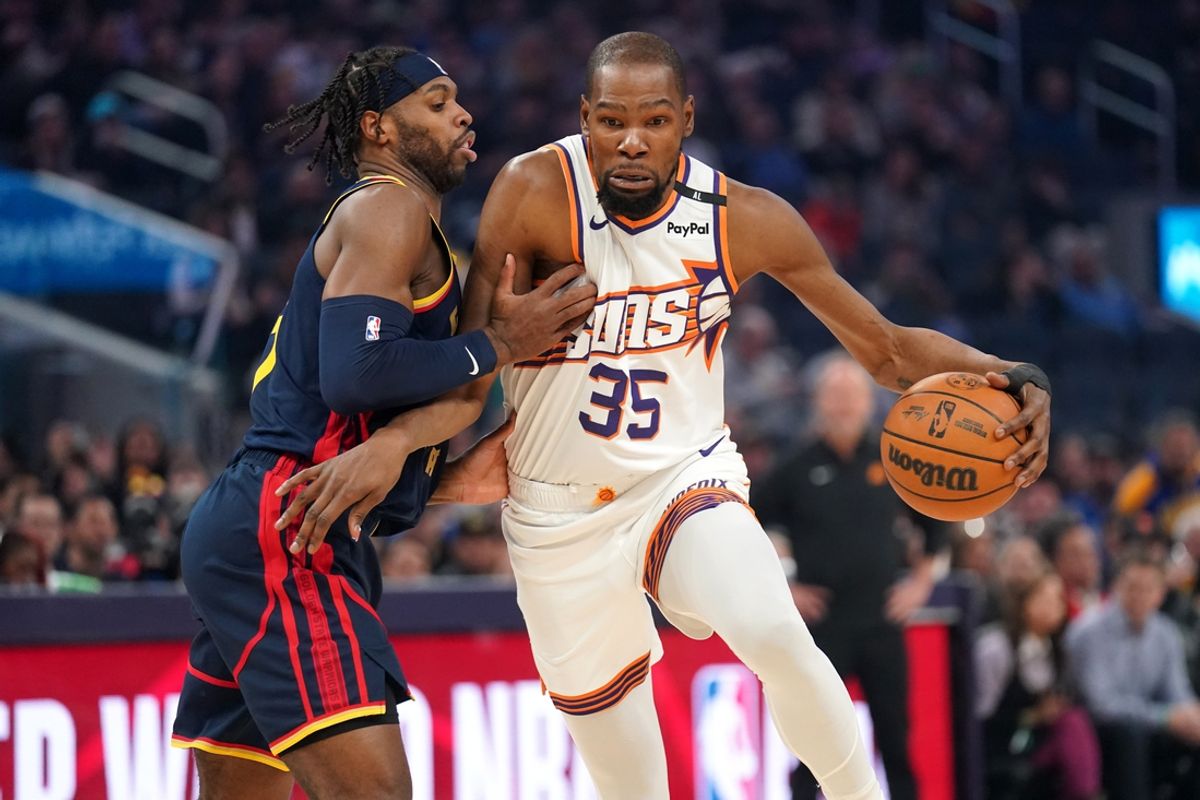 Jan 31, 2025; San Francisco, California, USA; Phoenix Suns forward Kevin Durant (35) dribbles the ball next to Golden State Warriors guard Buddy Hield (7) in the first quarter at the Chase Center. Mandatory Credit: Cary Edmondson-Imagn Images