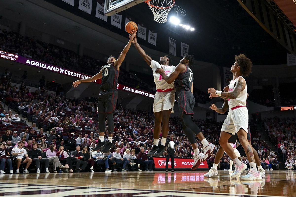 Jan 28, 2025; College Station, Texas, USA; Oklahoma Sooners guard Jeremiah Fears (0) attempts to lay up the ball as Texas A&M Aggies forward Henry Coleman III (15) defends during the second half at Reed Arena. The Aggies defeated the Sooners 75-68. Mandatory Credit: Maria Lysaker-Imagn Images