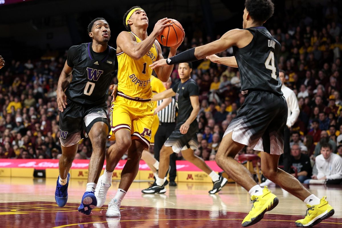 Feb 1, 2025; Minneapolis, Minnesota, USA; Minnesota Golden Gophers guard Isaac Asuma (1) shoots as Washington Huskies guards DJ Davis (4) Mekhi Mason (0) defend during the first half at Williams Arena. Mandatory Credit: Matt Krohn-Imagn Images