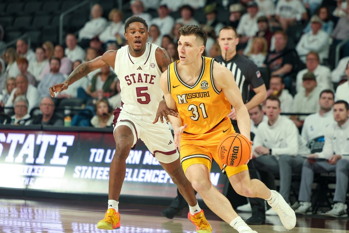 Feb 1, 2025; Starkville, Mississippi, USA; Missouri Tigers guard Caleb Grill (31) drives to the basket against Mississippi State Bulldogs guard Shawn Jones Jr. (5) during the first half at Humphrey Coliseum. Mandatory Credit: Wesley Hale-Imagn Images