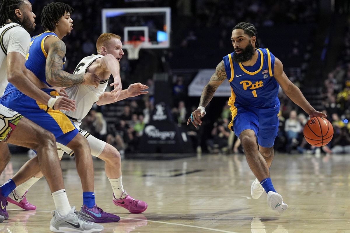 Feb 1, 2025; Winston-Salem, North Carolina, USA; Pittsburgh Panthers guard Damian Dunn (1) drives to the basket defended by Wake Forest Demon Deacons guard Cameron Hildreth (6) during the second half at Lawrence Joel Veterans Memorial Coliseum. Mandatory Credit: Jim Dedmon-Imagn Images