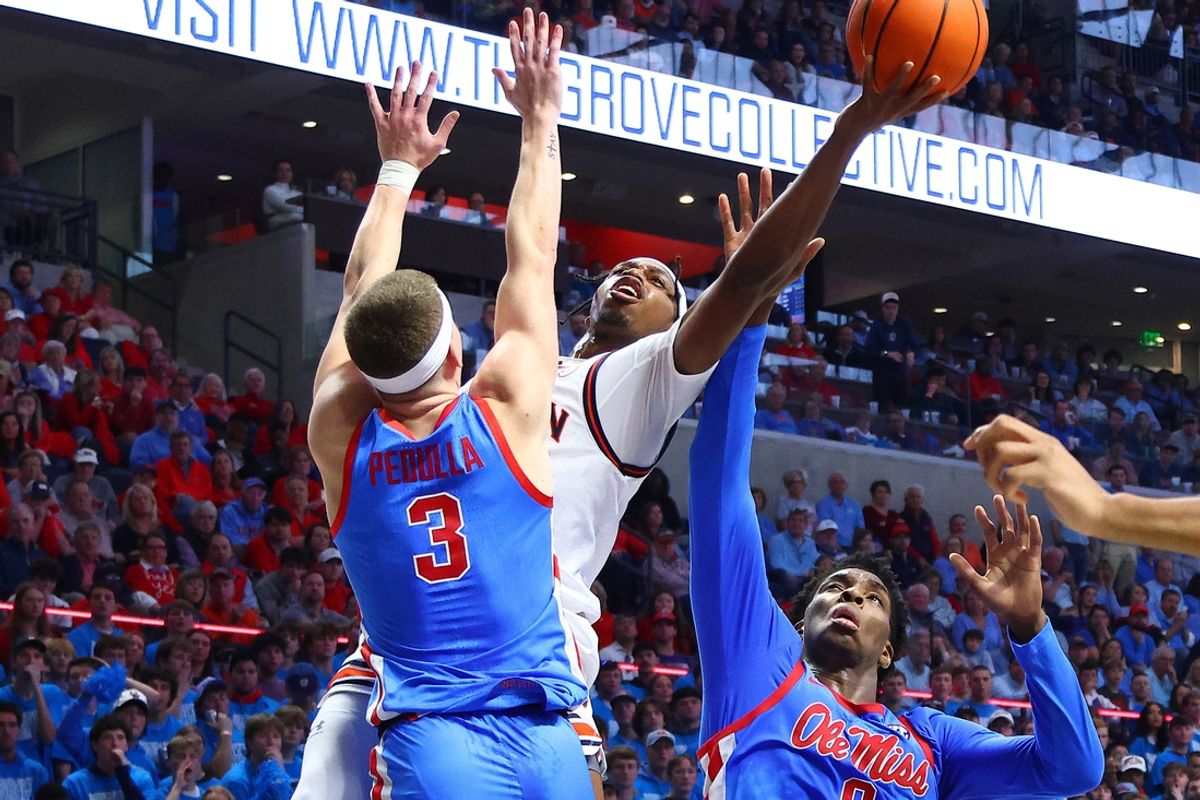 Feb 1, 2025; Oxford, Mississippi, USA; Auburn Tigers guard Denver Jones (2) drives to the basket as Mississippi Rebels guard TJ Caldwell (2) and forward Malik Dia (0) during the first half at The Sandy and John Black Pavilion at Ole Miss. Mandatory Credit: Petre Thomas-Imagn Images