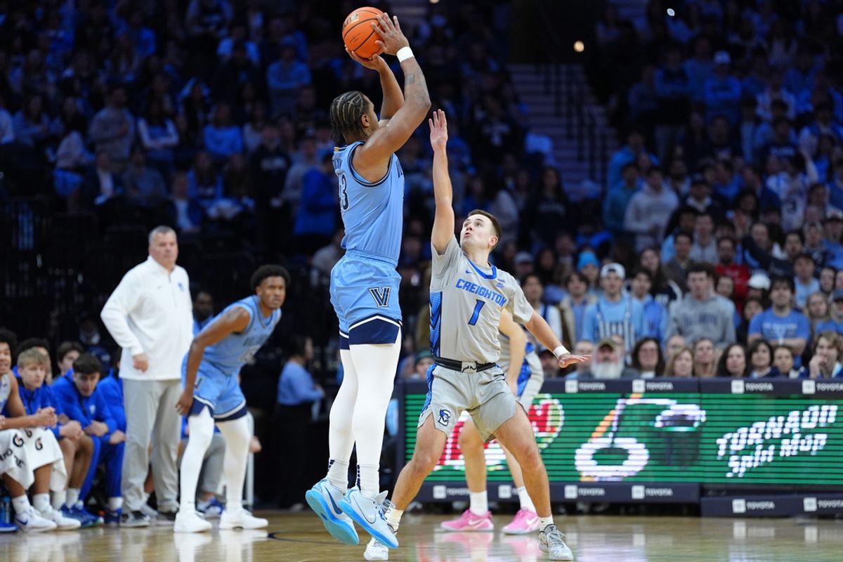 Feb 1, 2025; Philadelphia, Pennsylvania, USA; Villanova Wildcats forward Eric Dixon (43) shoots the ball against Creighton Bluejays guard Steven Ashworth (1) in the first half at Wells Fargo Center. Mandatory Credit: Kyle Ross-Imagn Images