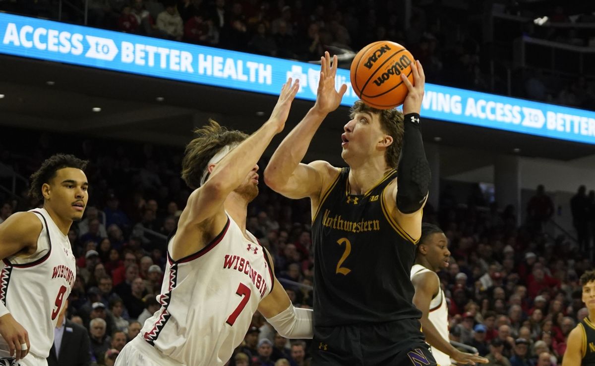 Feb 1, 2025; Evanston, Illinois, USA; Wisconsin Badgers forward Carter Gilmore (7) defends Northwestern Wildcats forward Nick Martinelli (2) during the second half at Welsh-Ryan Arena. Mandatory Credit: David Banks-Imagn Images