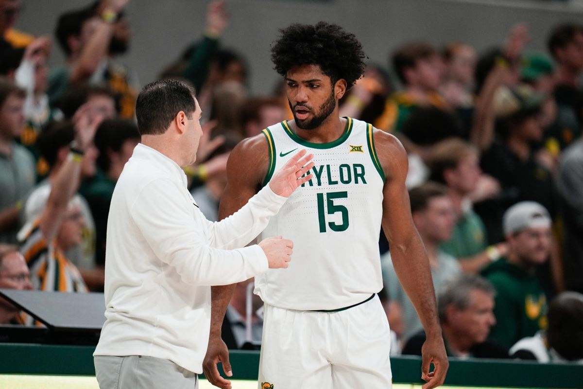 Feb 1, 2025; Waco, Texas, USA;  Baylor Bears head coach Scott Drew speaks with forward Norchad Omier (15) during a break in play against the Kansas Jayhawks in the first half at Paul and Alejandra Foster Pavilion. Mandatory Credit: Chris Jones-Imagn Images
