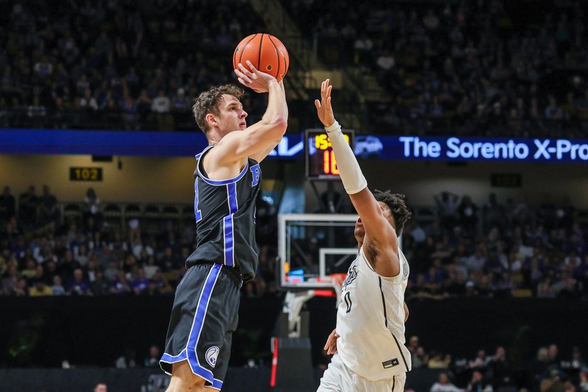 Feb 1, 2025; Orlando, Florida, USA; Brigham Young Cougars guard Trevin Knell (21) shoots over UCF Knights guard Jordan Ivy-Curry (0) during the second half at Addition Financial Arena. Mandatory Credit: Mike Watters-Imagn Images
