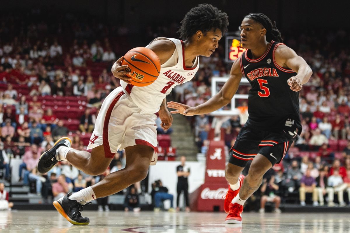 Feb 1, 2025; Tuscaloosa, Alabama, USA; Alabama Crimson Tide guard Aden Holloway (2) drives the ball against Georgia Bulldogs guard Silas Demary Jr. (5) during the second half at Coleman Coliseum. Mandatory Credit: Will McLelland-Imagn Images