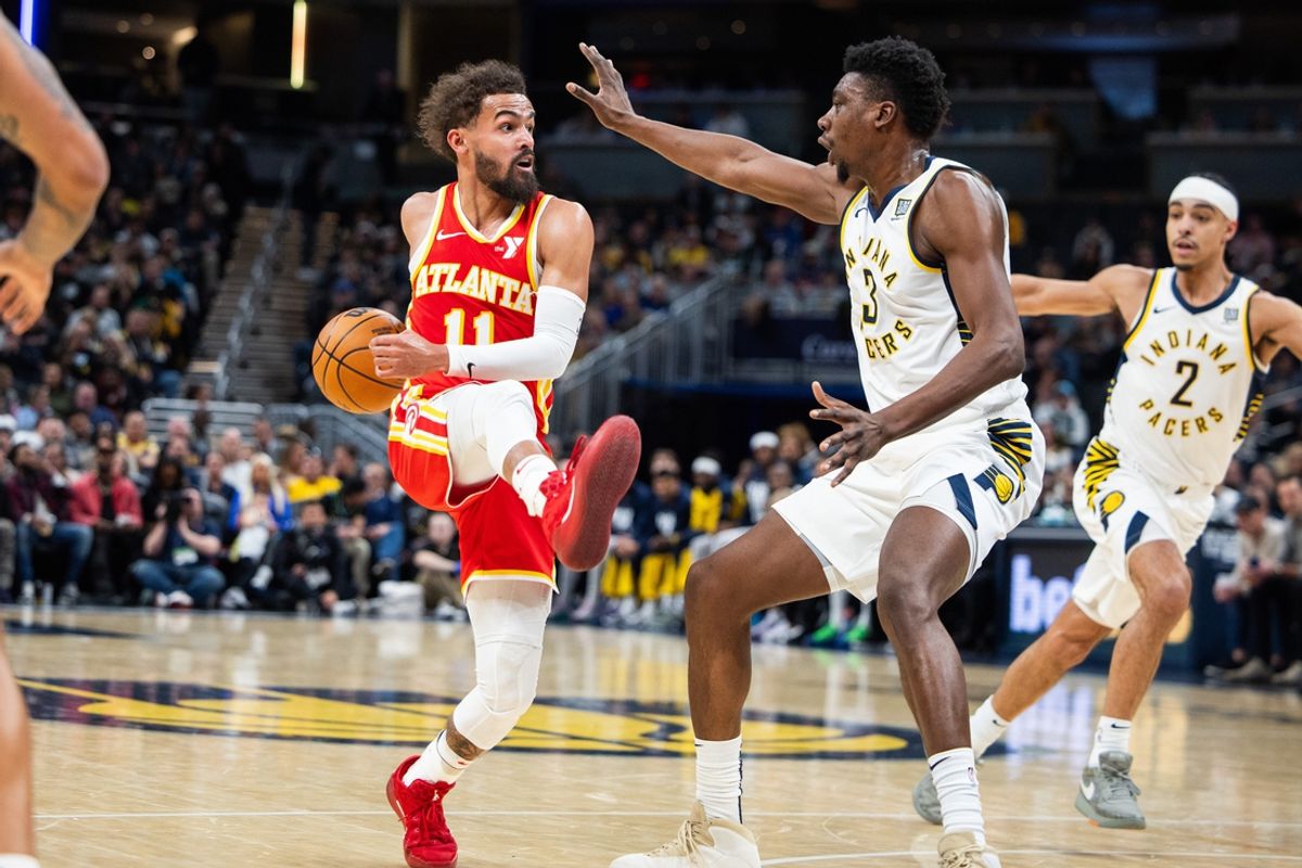Feb 1, 2025; Indianapolis, Indiana, USA; Atlanta Hawks guard Trae Young (11) passes the ball against Indiana Pacers center Thomas Bryant (3) in the first half at Gainbridge Fieldhouse. Mandatory Credit: Trevor Ruszkowski-Imagn Images