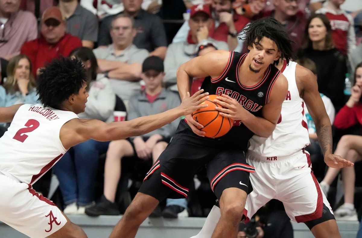 Feb 1, 2025; Tuscaloosa, AL, USA; Alabama guard Aden Holloway (2) reaches in to try and stip the ball as Georgia forward Asa Newell (14) drives to the basket at Coleman Coliseum. Alabama downed Georgia 90-69. Mandatory Credit: Gary Cosby Jr.-Tuscaloosa News