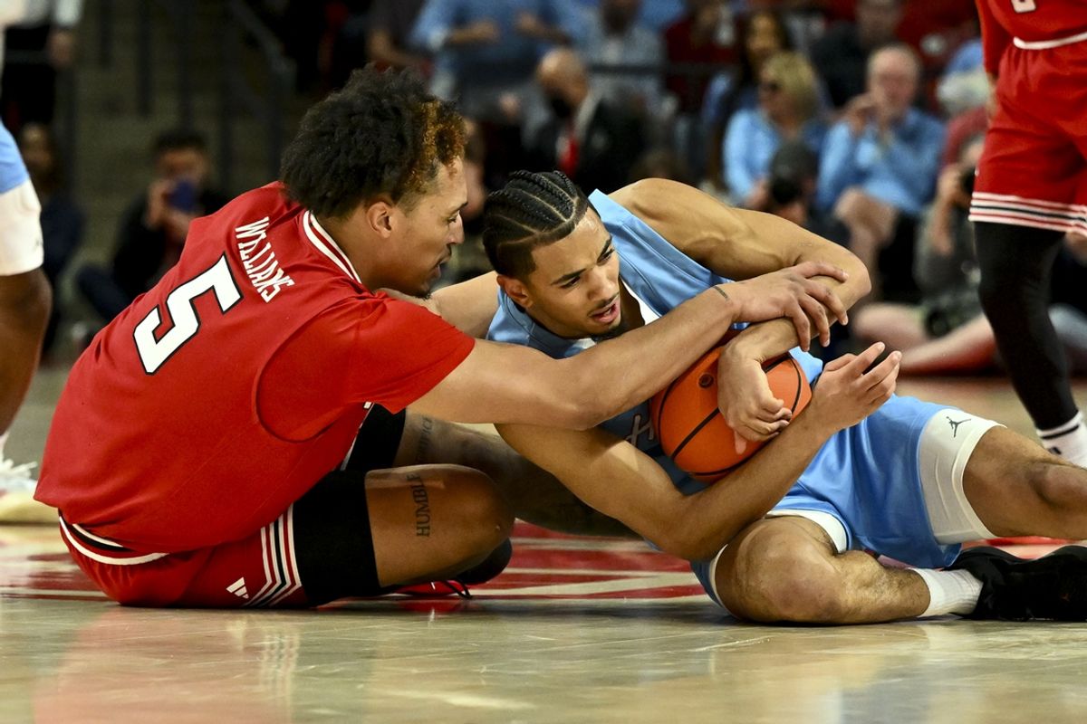 Feb 1, 2025; Houston, Texas, USA; Houston Cougars guard Milos Uzan (7) and Texas Tech Red Raiders forward Darrion Williams (5) battle for a loose ball during the first half at Fertitta Center. Mandatory Credit: Maria Lysaker-Imagn Images