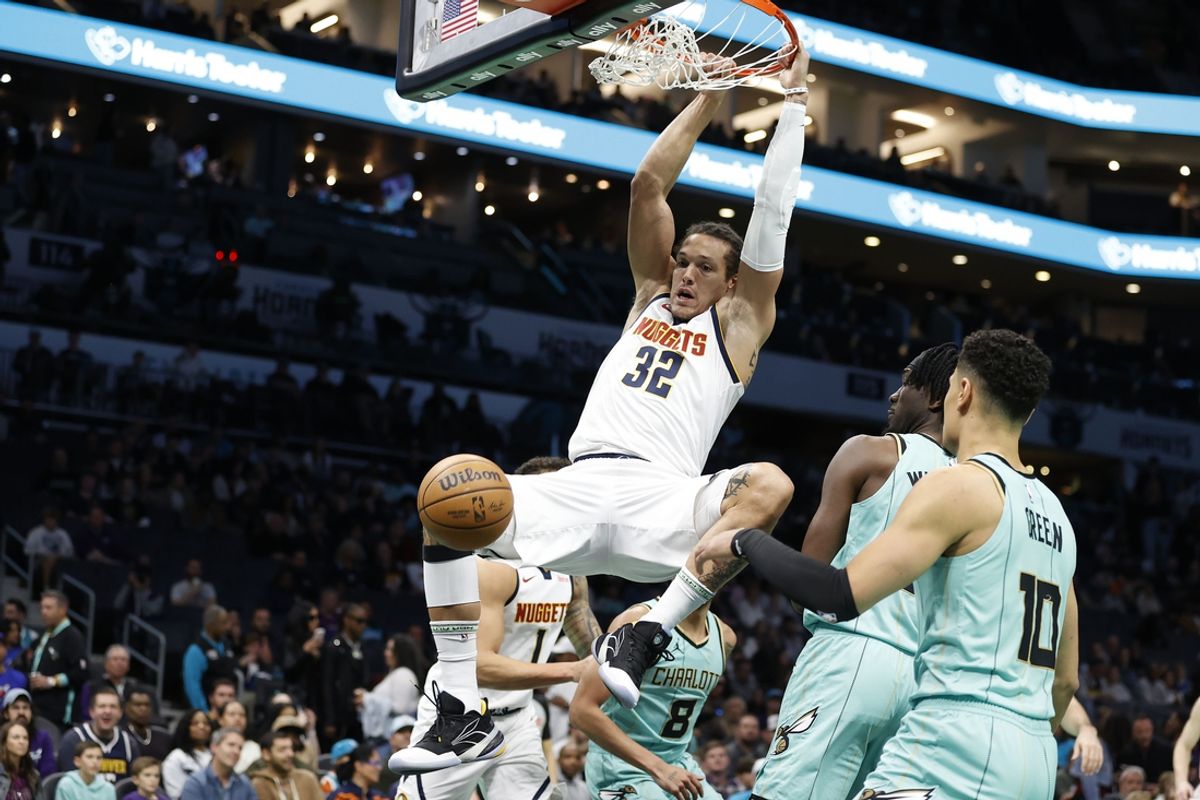 Feb 1, 2025; Charlotte, North Carolina, USA; Denver Nuggets forward Aaron Gordon (32) follows through on a slam dunk during the first quarter against the Charlotte Hornets at Spectrum Center. Mandatory Credit: Brian Westerholt-Imagn Images