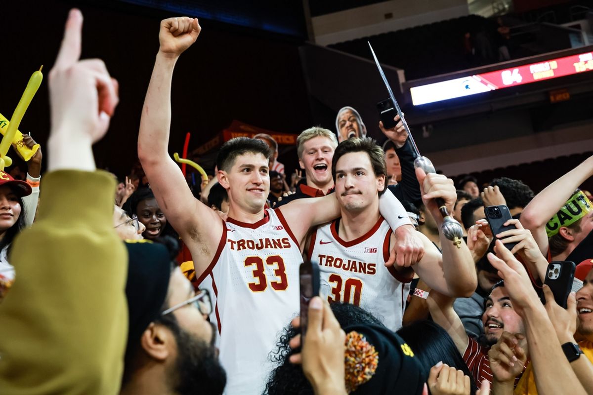 Feb 1, 2025; Los Angeles, California, USA;  USC Trojans players celebrate with fans in the student section after defeating the Michigan State Spartans at Galen Center. Mandatory Credit: William Navarro-Imagn Images
