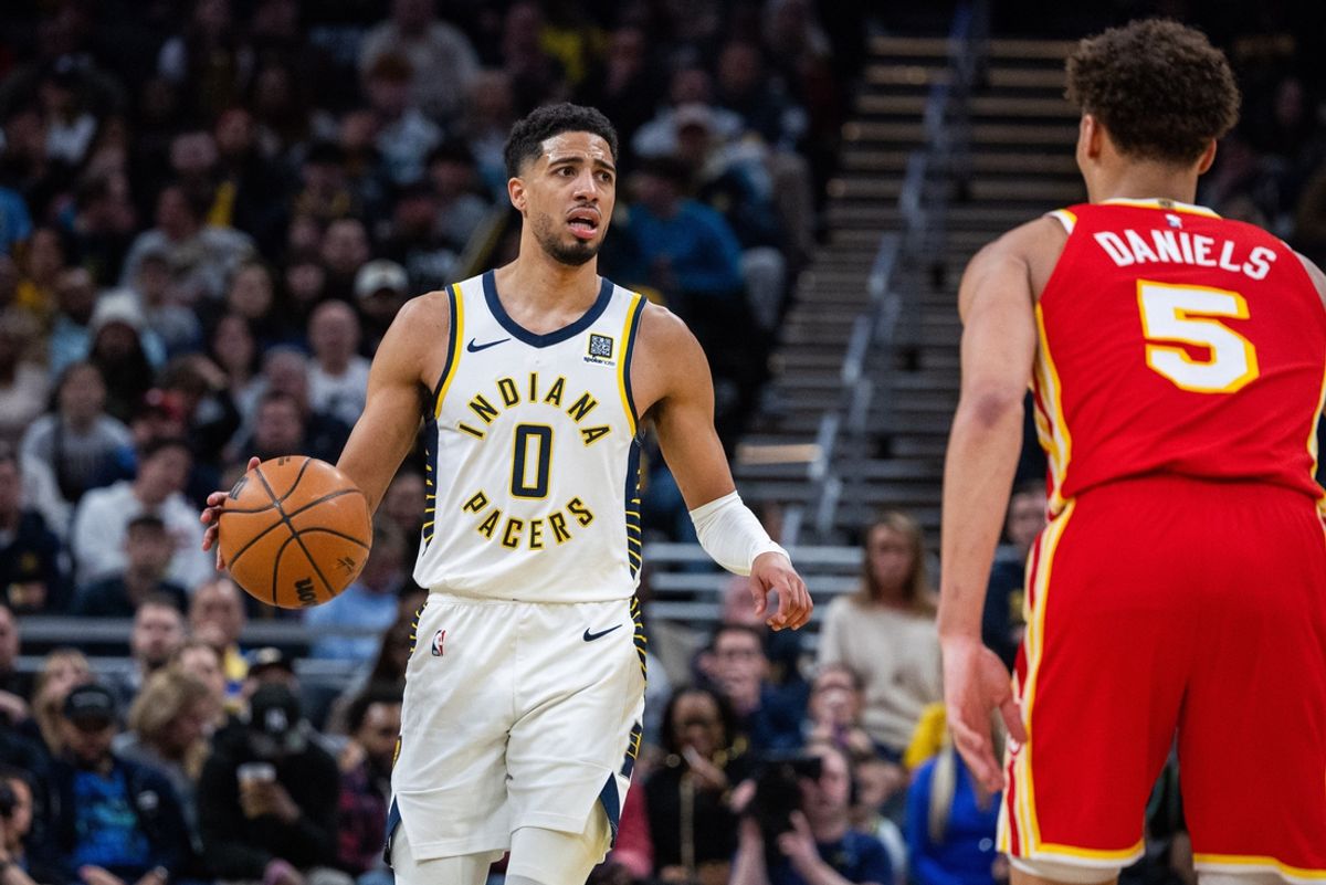 Feb 1, 2025; Indianapolis, Indiana, USA; Indiana Pacers guard Tyrese Haliburton (0) dribbles the ball against Atlanta Hawks guard Dyson Daniels (5) in the second half at Gainbridge Fieldhouse. Mandatory Credit: Trevor Ruszkowski-Imagn Images